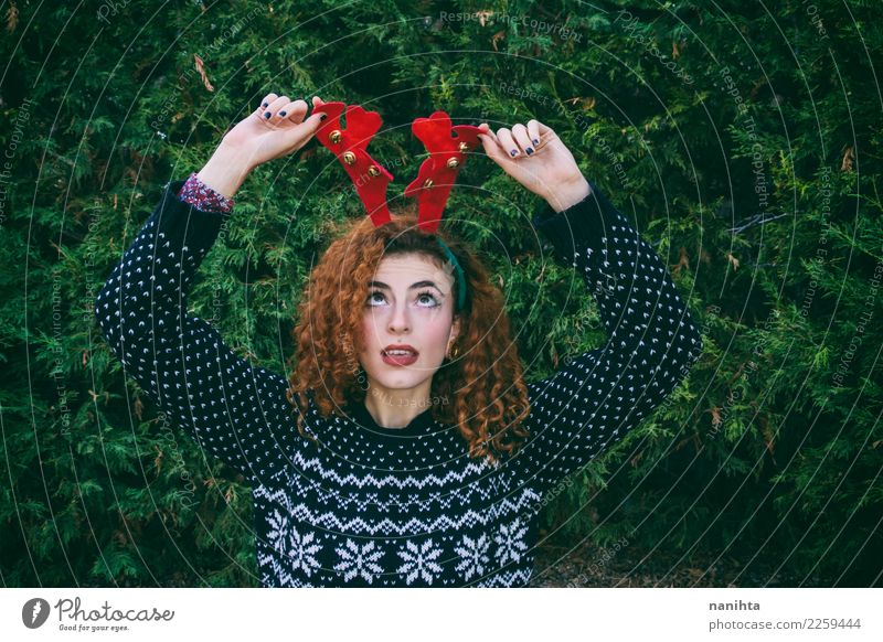 Young woman making a funny face at christmas Style Design Joy Feasts & Celebrations Christmas & Advent New Year's Eve Human being Feminine Youth (Young adults)
