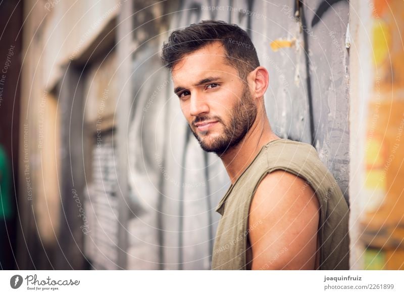 young handsome man with t-shirt against a wall in street Lifestyle Style Happy Human being Boy (child) Man Adults Town Street Fashion Jeans Cool (slang)