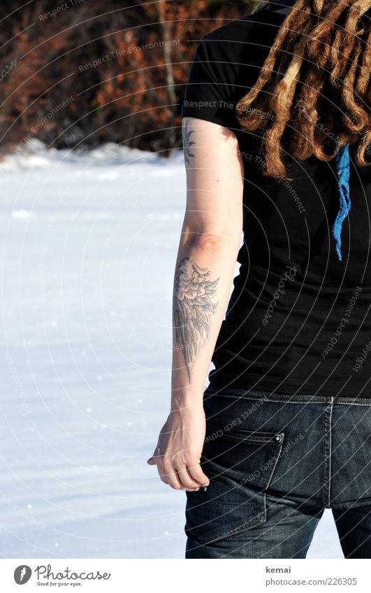One cold arm Lifestyle Winter Snow Human being Woman Adults Hair and hairstyles Arm Hand Bottom 1 Tattoo T-shirt Jeans Brunette Dreadlocks Stand Exceptional