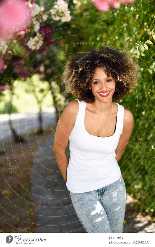 Young black woman with afro hairstyle smiling in urban park Lifestyle Style Beautiful Hair and hairstyles Summer Human being Feminine Young woman