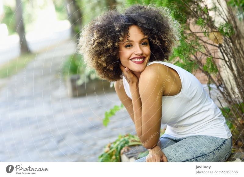 Mixed woman with afro hairstyle smiling in urban park Lifestyle Style Happy Beautiful Hair and hairstyles Face Human being Feminine Young woman