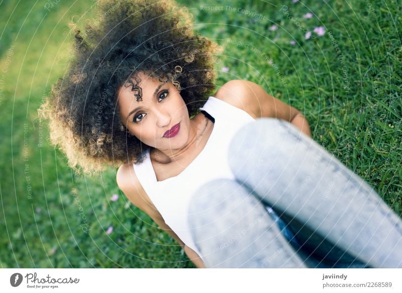 Mixed woman with afro hairstyle sitting in urban park Lifestyle Style Happy Beautiful Hair and hairstyles Face Summer Human being Feminine Young woman