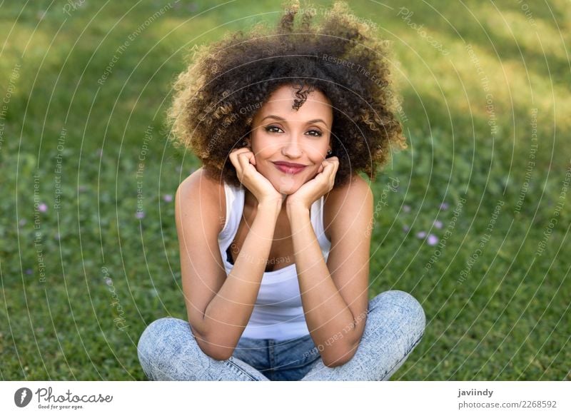 Mixed woman with afro hairstyle smiling in urban park Lifestyle Style Happy Beautiful Hair and hairstyles Face Summer Human being Feminine Young woman