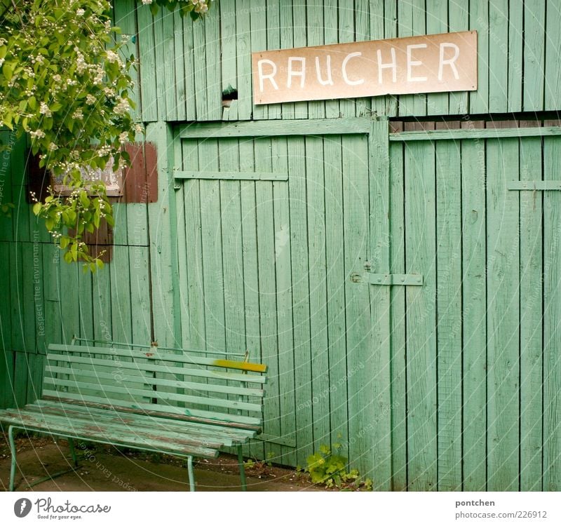 Health protection. Mint green bench in front of mint green wooden hut with cardboard sign smoker. Smoker's corner Wall (barrier) Wall (building) Bench bleed