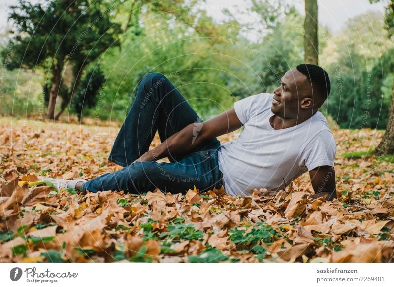 Park I. Contentment Vacation & Travel Human being Masculine Young man Youth (Young adults) Man Adults Culture Nature Autumn Leaf Jeans Lie Natural Tolerant