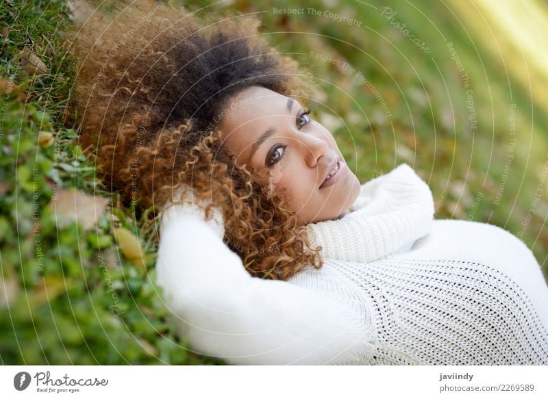 Young African American woman lying on grass Lifestyle Beautiful Hair and hairstyles Face Human being Feminine Young woman Youth (Young adults) Woman Adults Head