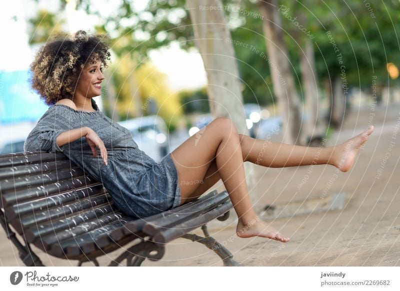 Woman with afro hairstyle sitting on a bench moving her legs Lifestyle Style Happy Beautiful Hair and hairstyles Face Human being Feminine Young woman