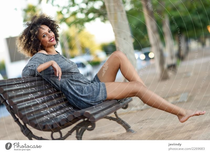 Young black woman with afro hairstyle sitting on a bench Lifestyle Style Beautiful Hair and hairstyles Face Human being Feminine Young woman