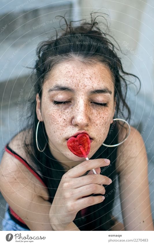 Portrait of Young woman eating lollipops Lollipop Lifestyle Joy Beautiful Face Healthy Wellness Summer Sun Valentine's Day Human being Girl Youth (Young adults)