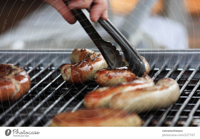 Bratwurst is grasped Food Sausage Gastronomy Hand Barbecue (apparatus) Brown Pair of pliers Take Grating Crust Roasted BBQ season Thuringia Colour photo