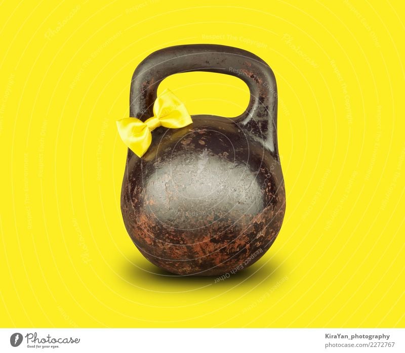 Old kettlebell with yellow tied bow on yellow background Health care Athletic Valentine's Day Carnival Easter Oktoberfest Birthday Sports Fitness
