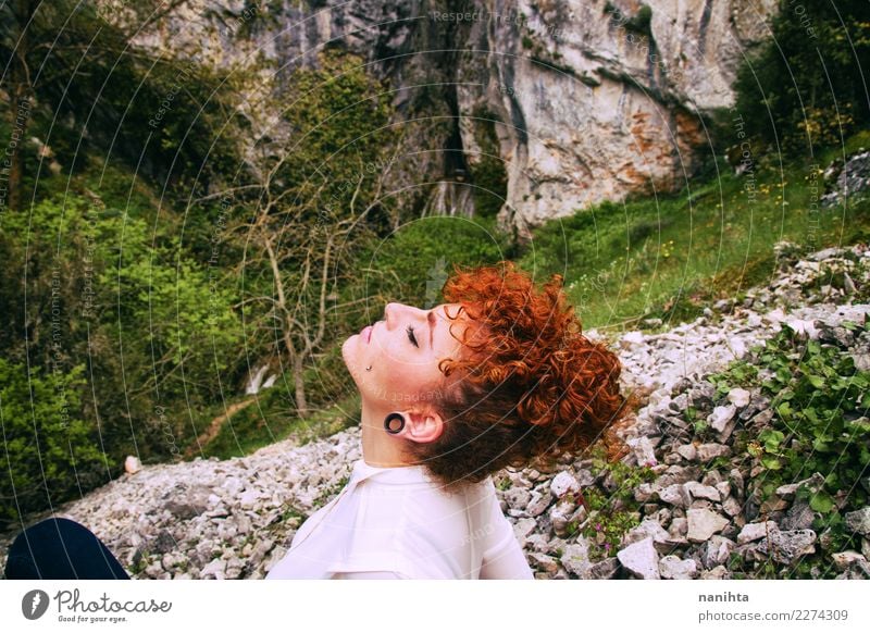 Young redhead woman breathing pure air in nature Lifestyle Beautiful Hair and hairstyles Healthy Wellness Well-being Senses Relaxation Meditation