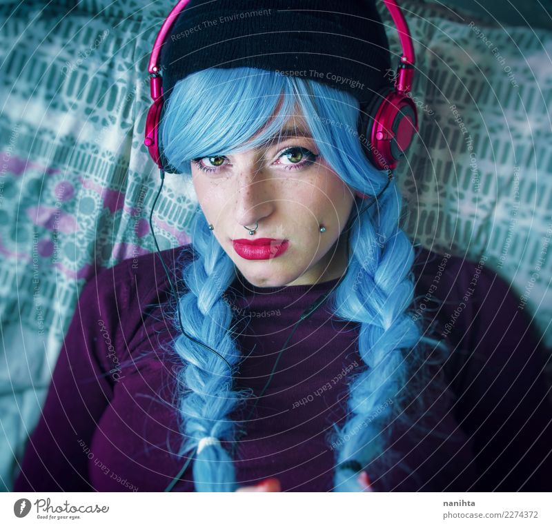 Young woman with blue hair is listening to music Lifestyle Style Beautiful Hair and hairstyles Skin Face Freckles Leisure and hobbies Human being Feminine