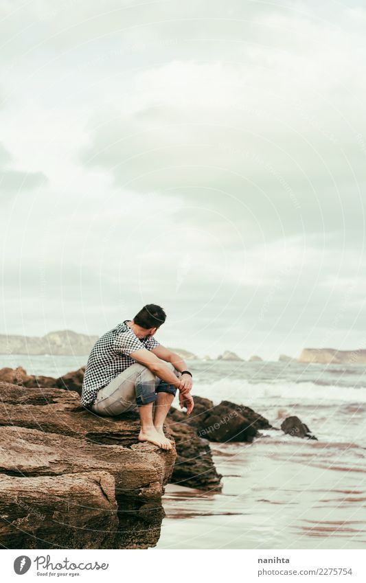Man sitting near the sea in a cloudy day Lifestyle Wellness Well-being Senses Relaxation Vacation & Travel Tourism Adventure Far-off places Freedom Beach Ocean