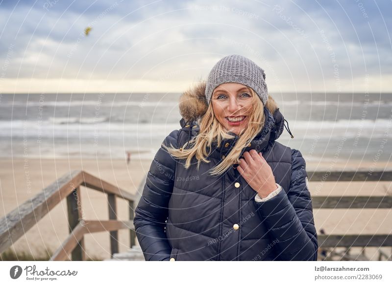 Middle-aged woman braving a cold winter day at the sea Happy Beautiful Face Vacation & Travel Adventure Beach Winter Woman Adults 45 - 60 years Sand Autumn