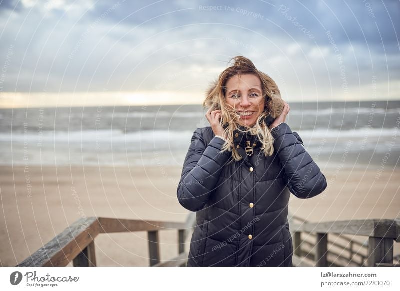 Middle-aged woman braving a cold winter day at the sea Happy Beautiful Face Leisure and hobbies Vacation & Travel Adventure Beach Winter Woman Adults 1