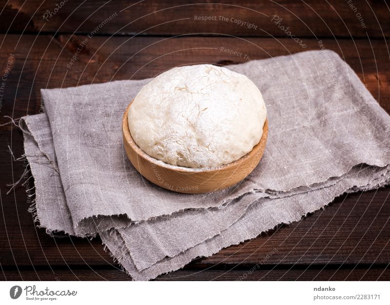 yeast dough in a wooden bowl Dough Baked goods Bread Bowl Table Kitchen Wood Eating Fresh Natural Above Brown White Yeast background Preparation food healthy