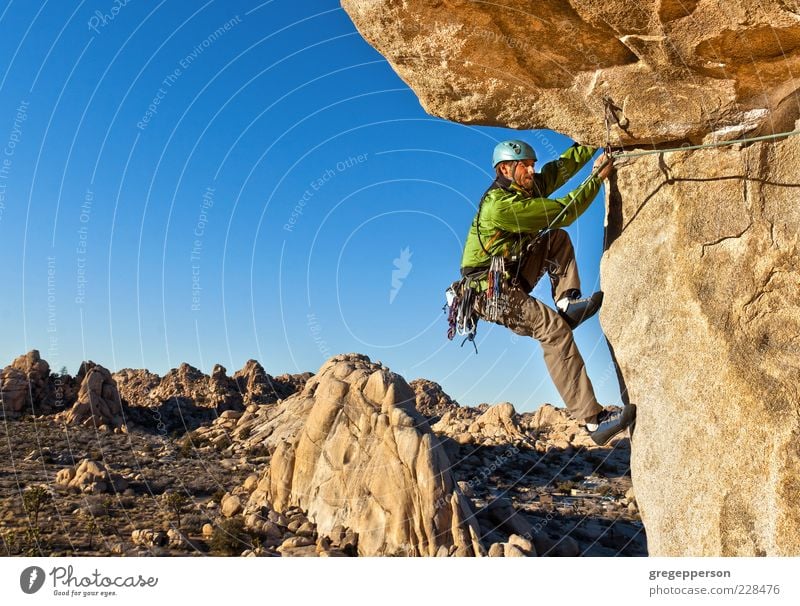 Rock climber clinging to a cliff. Adventure Freedom Mountain Climbing Mountaineering Success Rope 1 Human being Nature Landscape Peak Hang Hiking Athletic Tall