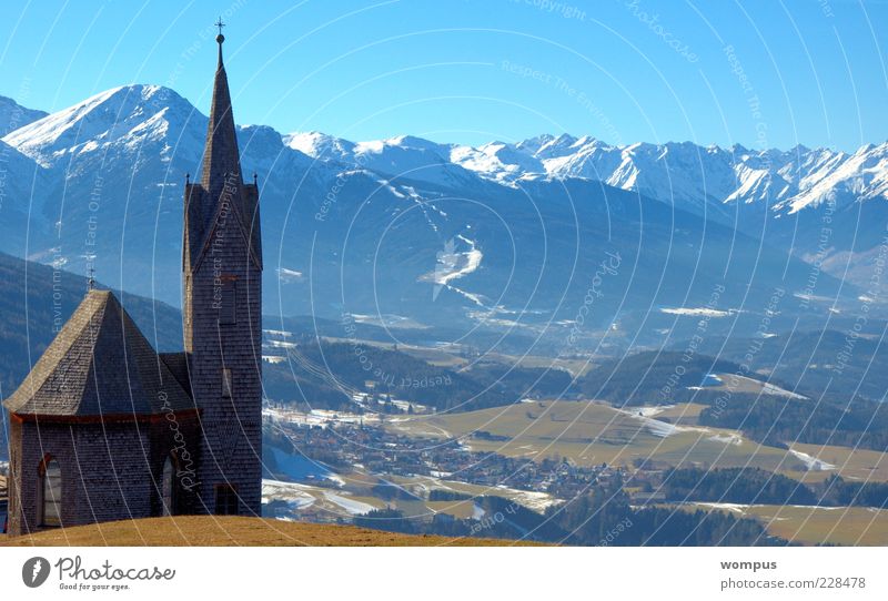 Winterende in Tirol Landscape Sky Cloudless sky Beautiful weather Alps Mountain Snowcapped peak Church Blue Brown Green White Tourism Colour photo Exterior shot