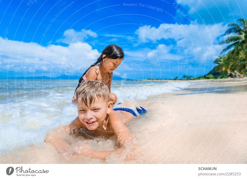 Cute kids having fun on the sunny tropical beach. Lifestyle Joy Freedom Summer Island Child Human being Girl Boy (child) Infancy 2 3 - 8 years Youth culture