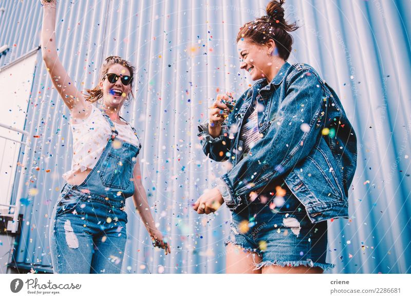Young adult best friends cheering with confetti on party Joy Happy Night life Entertainment Party Event Music Club Disco Feasts & Celebrations Dance