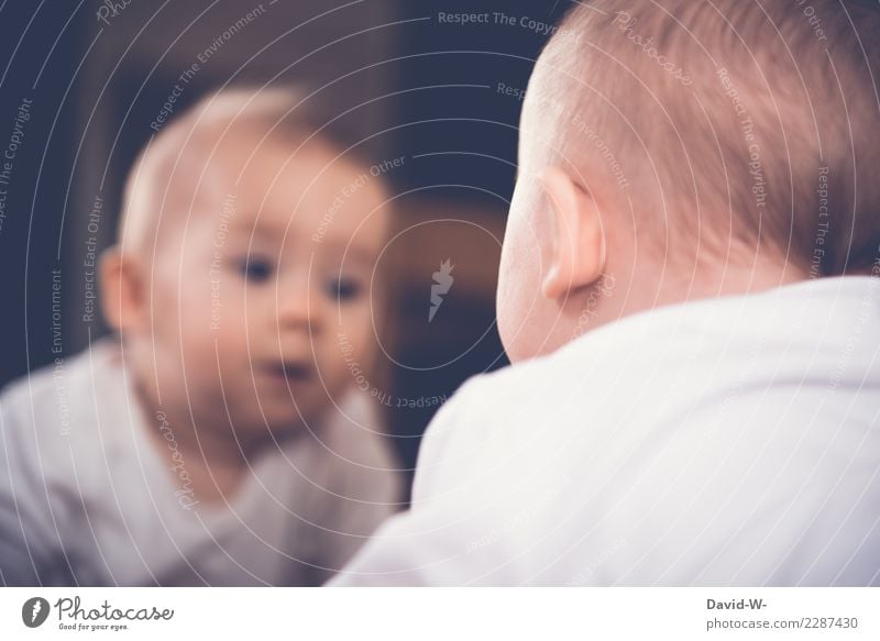 Baby looks in the mirror and discovers his reflection Mirror Mirror image inquisitive explore inquisitorial curious Curiosity Cute Infancy Child Observe