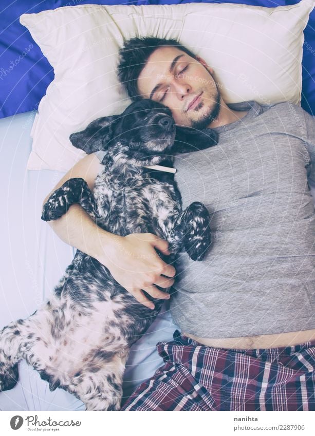 Young man sleeping with his dog Lifestyle Wellness Harmonious Well-being Relaxation Bed Human being Masculine Youth (Young adults) Man Adults 1 30 - 45 years
