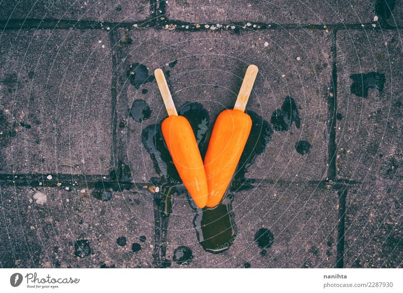 Two orange ice cream melted in the ground Food Dessert Ice cream Nutrition Eating Vegetarian diet Summer vacation Climate change Asphalt Dirty Authentic Simple