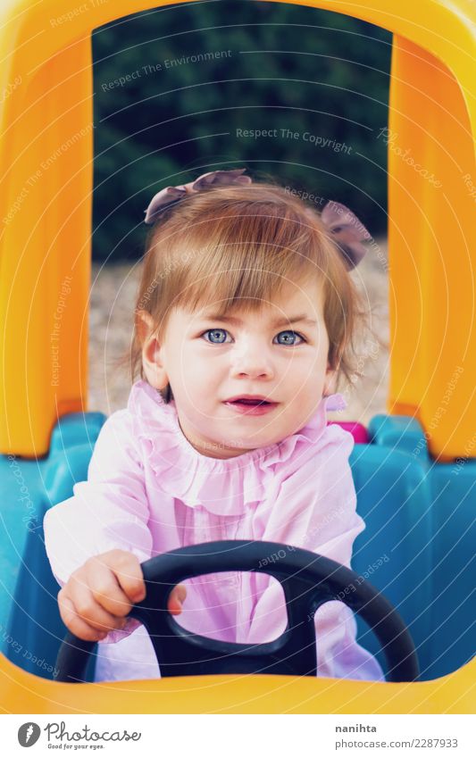Young girl playing to driving a toy car Lifestyle Joy Wellness Playing Children's game Adventure Human being Feminine Baby Girl Infancy 1 1 - 3 years Toddler