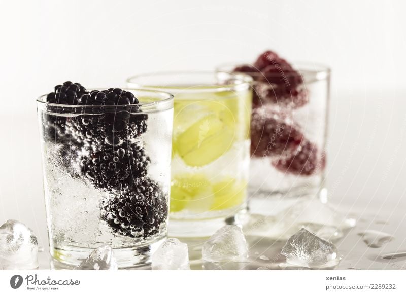Three chilled thirst quenchers with fruit and mineral water. Blackberry, grape or raspberry Beverage Cold drink Ice cube Fruit Raspberry Bunch of grapes