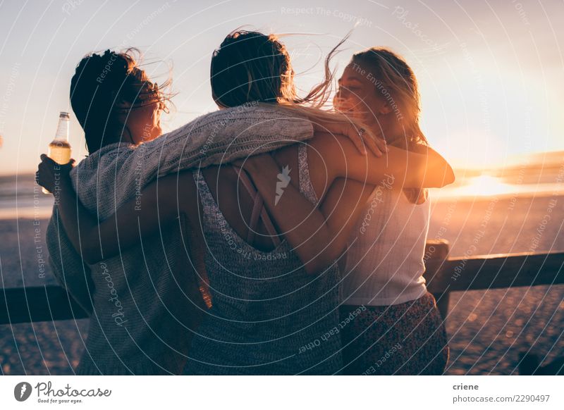 Group of female friends hugging each other in sunset Drinking Beer Lifestyle Leisure and hobbies Vacation & Travel Summer Summer vacation Sun Sunbathing Beach