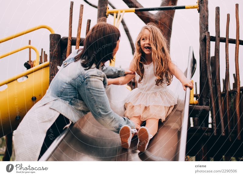 Mother and daughter having fun on playground together Joy Happy Playing Parents Adults Family & Relations Infancy Playground Together Emotions Daughter slide