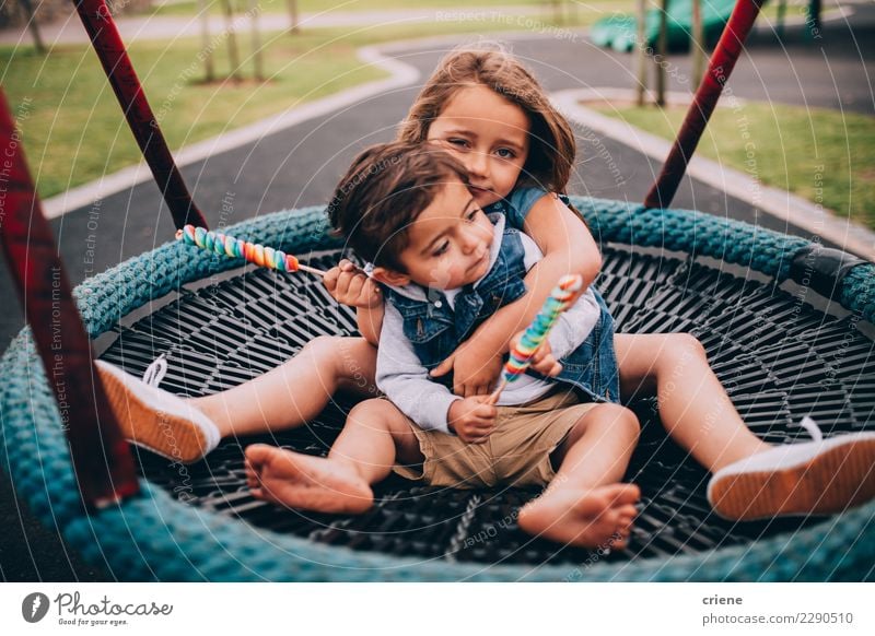 Adorable toddler siblings hugging each other on swing Playing Child Human being Toddler Sister Family & Relations Infancy 2 Playground Love Embrace Emotions