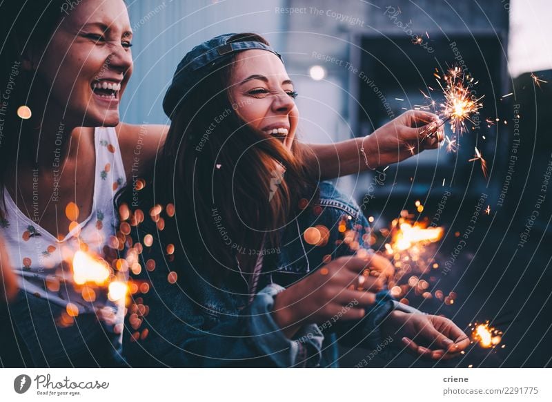 Young adult girlfriends celebrating with sparklers at night Happy Night life Entertainment Party Event Going out Feasts & Celebrations Dance Christmas & Advent