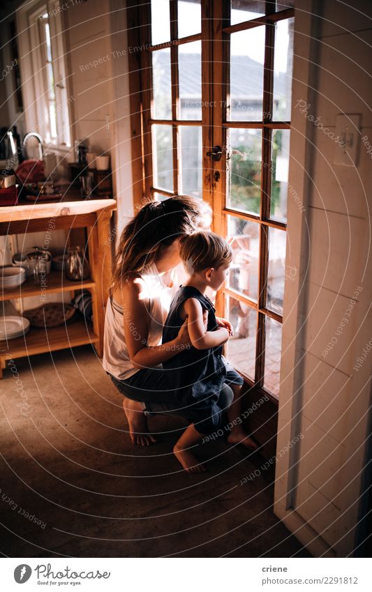 Mother and little boy looking out of the window together Happy Parents Adults Infancy Hut Wood Smiling Wait Together Modern Relationship Son door Home Strange