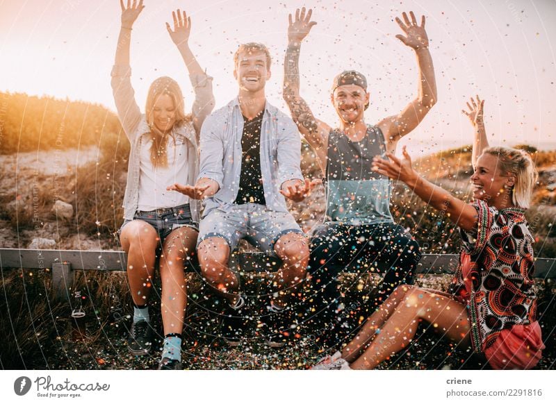 Group of hipster friends cheering with confetti in sunset Happy Party Feasts & Celebrations Dance New Year's Eve Birthday Friendship Youth (Young adults)
