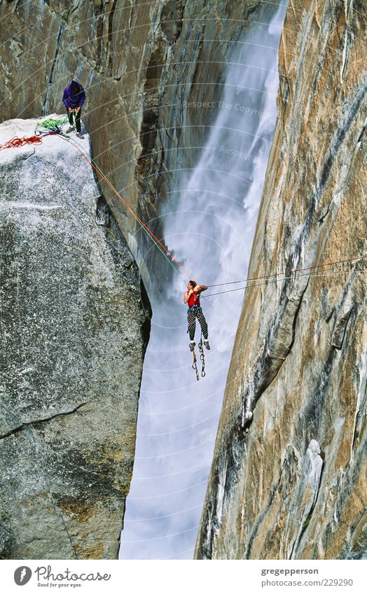 Rock climbing team reaching the summit. Adventure Mountain Sports Climbing Mountaineering Rope Friendship 2 Human being Peak Waterfall Athletic Tall Power