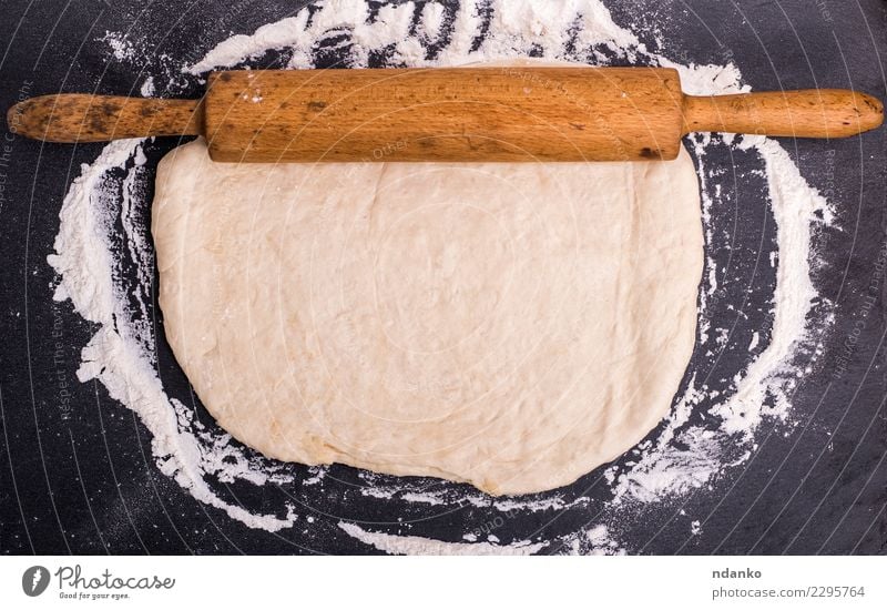 rolled dough of white wheat flou Dough Baked goods Bread Table Kitchen Wood Fresh Natural Above White Rolling pin Yeast background Preparation food healthy