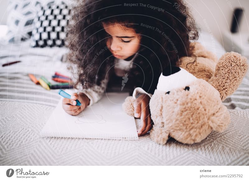 Little girl doing homework on bed at home Joy Happy Beautiful Child School Woman Adults Infancy Paper Smiling Dream Happiness Small Cute Black african drawing