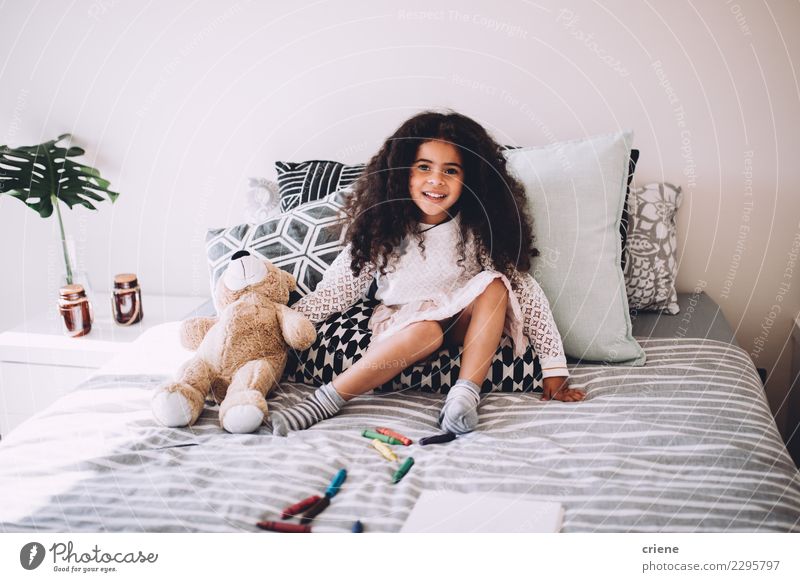 Little african girl sitting on bed with teddy bear smiling Joy Happy Beautiful Playing Child Human being Infancy Teddy bear Laughter Sit Jump Happiness Small