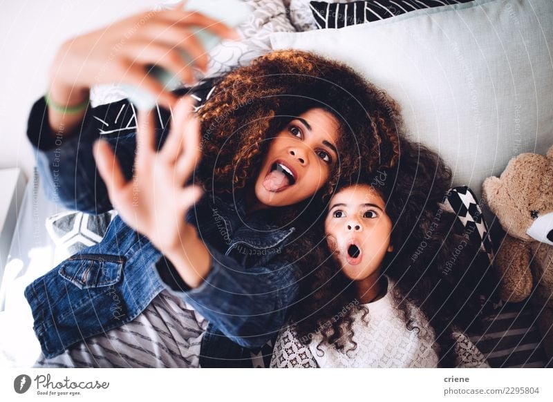 Young mom and daughter taking funny selfie with tablet Lifestyle Joy Happy Beautiful Child Telephone Woman Adults Parents Mother Family & Relations Smiling