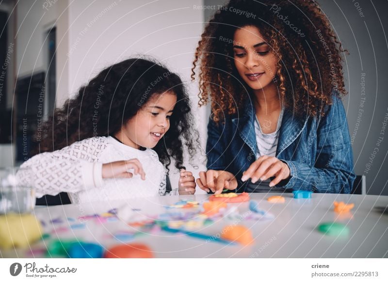 African Mother and daughter playing with toys together Joy Happy Playing Table Kindergarten Child School Woman Adults Parents Family & Relations Infancy Paper