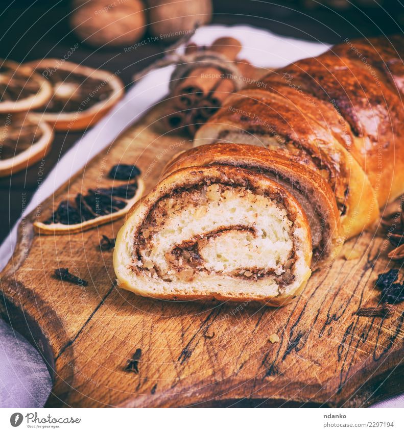 baked roll with cinnamon and nuts Bread Dessert Table Wood Fresh Delicious Above Brown Tradition cooking Slice sweet christmas Home Home-made food Baked goods