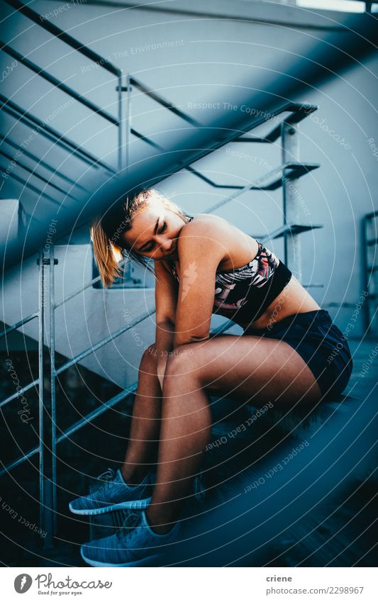 Caucasian fit woman sitting on stairs in sportswear Lifestyle Sports Woman Adults Fitness Bright Modern Determination Fatigue Resting running after Practice