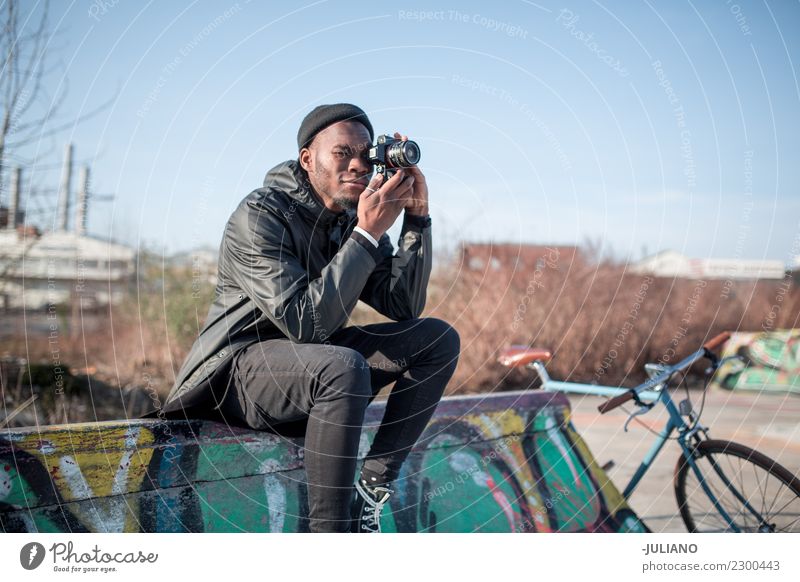 Young modern man sitting on halfpipe taking picture with Camera Modern Town City life Ice-skating Skate park Lifestyle Hipster Fashion Clothing Jacket Heat