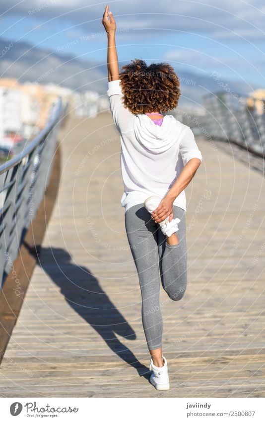 African american woman running outdoors Stock Photo by