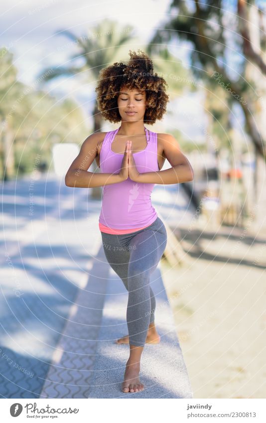 Black woman, afro hairstyle, doing yoga in the beach. Lifestyle Beautiful Body Hair and hairstyles Wellness Relaxation Meditation Leisure and hobbies Beach