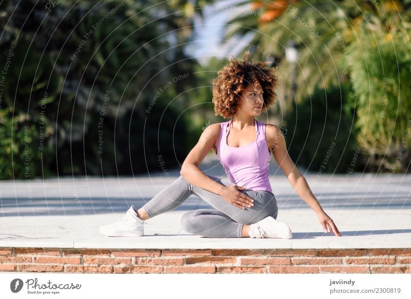 Black woman, afro hairstyle, doing yoga on promenade. Lifestyle Beautiful Body Hair and hairstyles Wellness Relaxation Meditation Leisure and hobbies Beach
