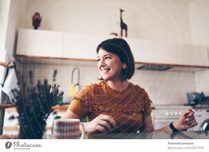 Young brunette woman sitting in a kitchen Lifestyle Elegant Style Feminine Young woman Youth (Young adults) Woman Adults 1 Human being 18 - 30 years already