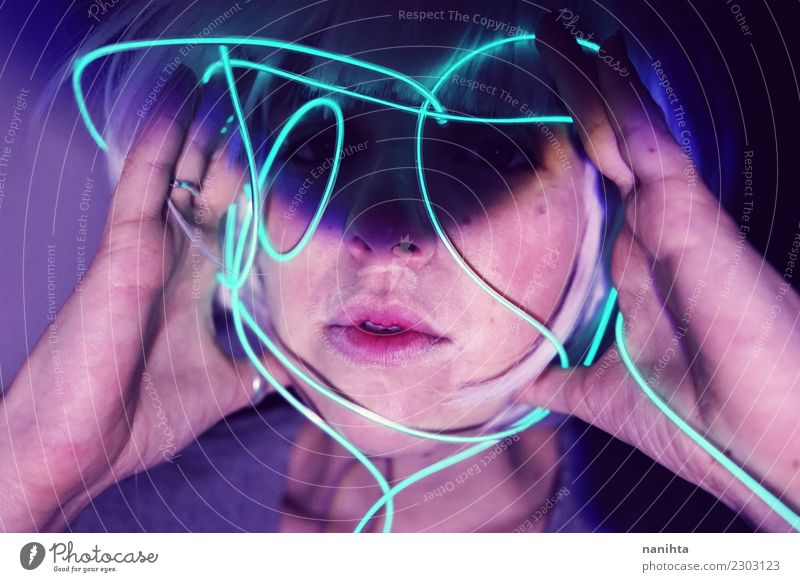 Abstract portrait of a young woman holding neon lights - a Royalty Free  Stock Photo from Photocase